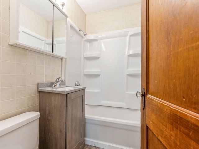 full bathroom with vanity, bathtub / shower combination, tile walls, toilet, and decorative backsplash