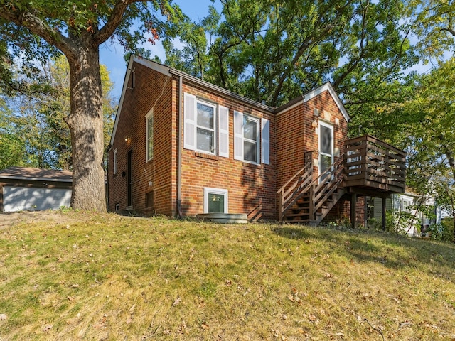 view of front facade with a front yard and a deck