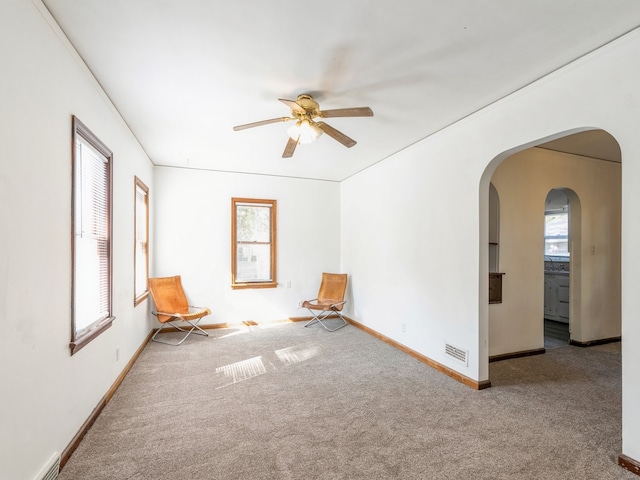 interior space with ceiling fan