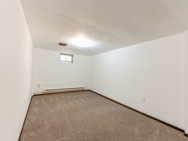 basement with a baseboard radiator and carpet