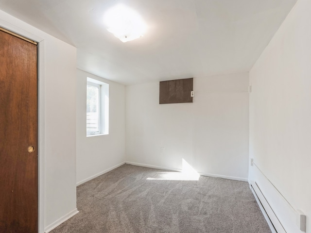 empty room featuring carpet floors and a baseboard radiator