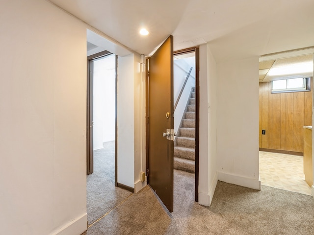 interior space featuring wood walls and light colored carpet