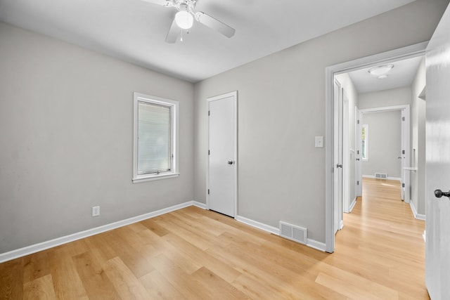 spare room with ceiling fan and light wood-type flooring