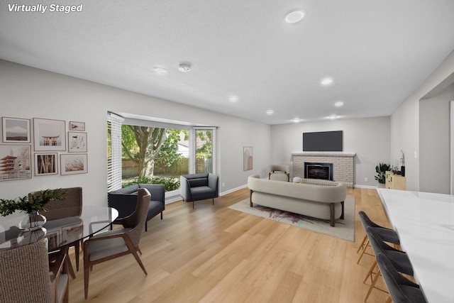 living room featuring a fireplace and light hardwood / wood-style flooring