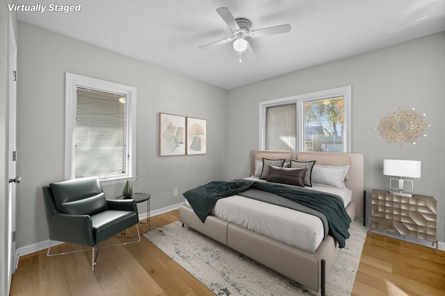 bedroom with ceiling fan and light hardwood / wood-style flooring