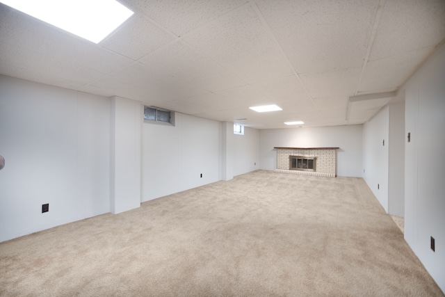 basement with a fireplace and carpet