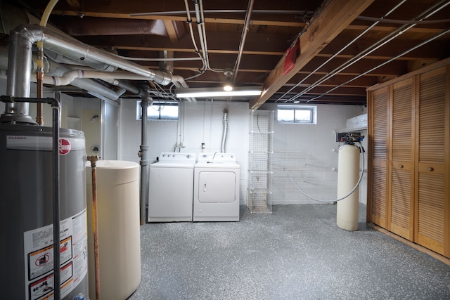 basement featuring independent washer and dryer and water heater