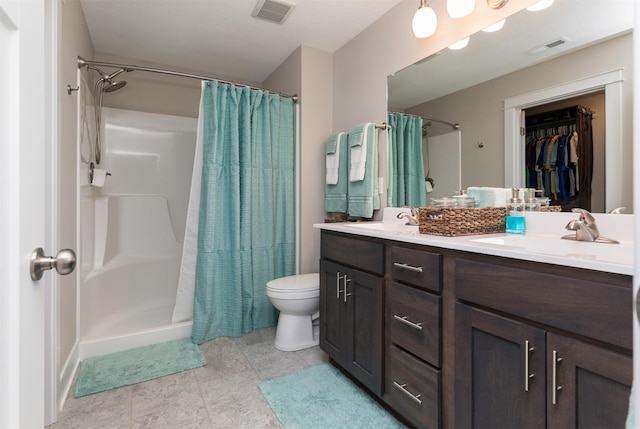 bathroom with double vanity, visible vents, a shower with shower curtain, and a sink