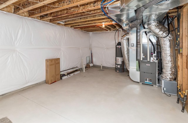 unfinished basement featuring heating unit and water heater