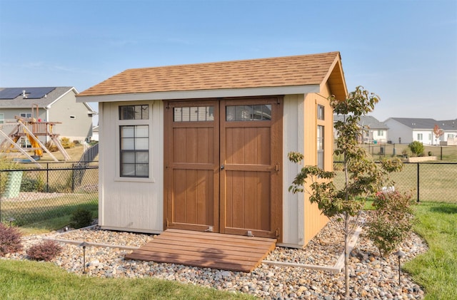 view of shed with a fenced backyard and a residential view