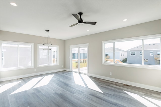 spare room with ceiling fan and light hardwood / wood-style flooring