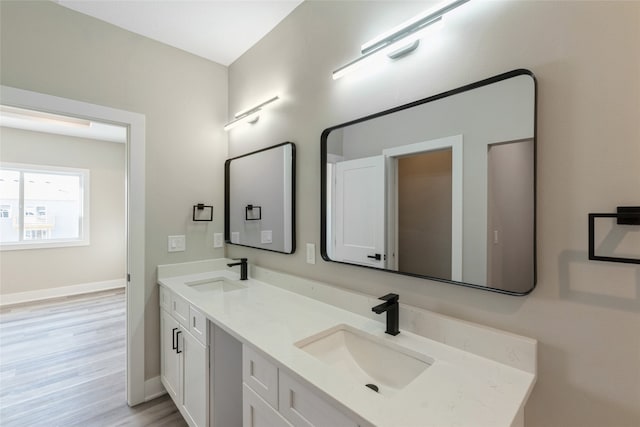 bathroom with vanity and hardwood / wood-style flooring