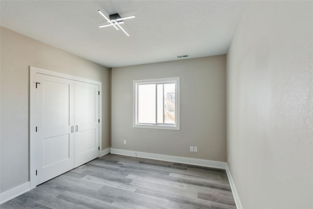 unfurnished bedroom with light wood-type flooring