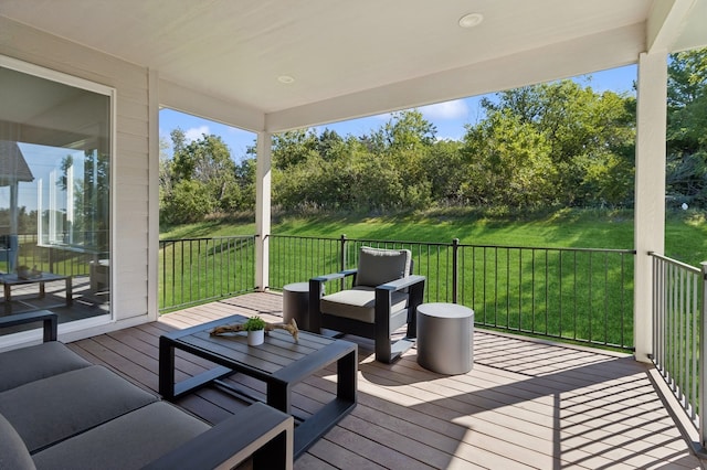 deck featuring outdoor lounge area and a lawn