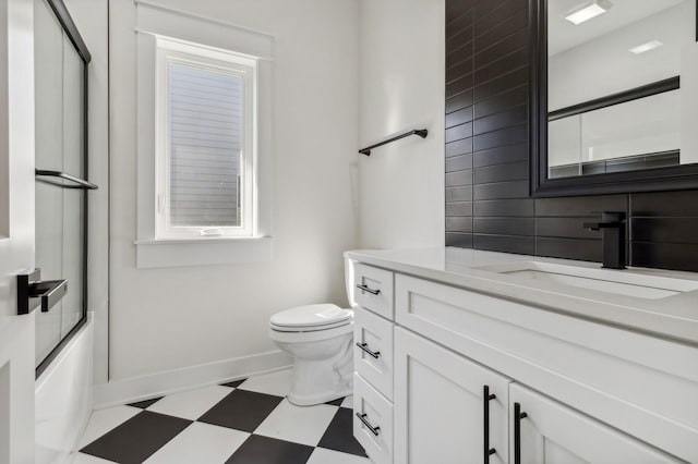 full bathroom with toilet, vanity, and combined bath / shower with glass door