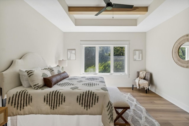 bedroom featuring beam ceiling, ceiling fan, and light hardwood / wood-style flooring