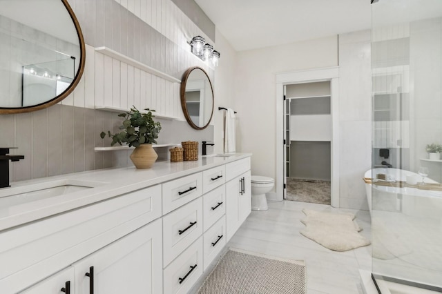 bathroom with vanity, toilet, and a shower with shower door