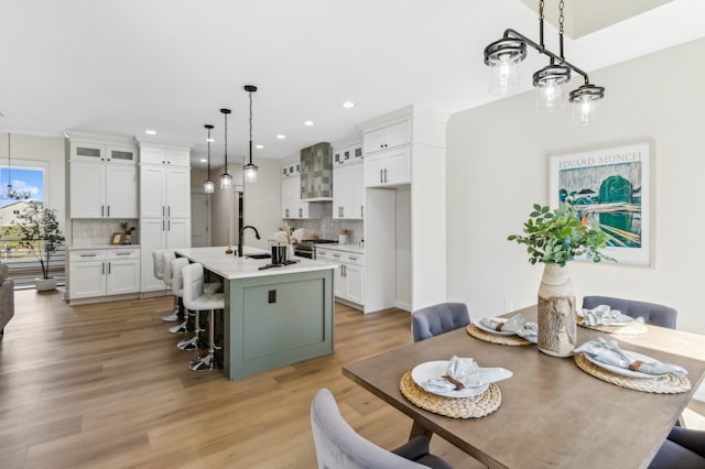 dining space with light hardwood / wood-style floors and sink