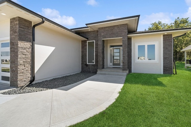 doorway to property featuring a lawn