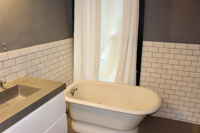 1510 9th St, Des Moines, IA 50314 - bathroom featuring vanity, a freestanding tub, and tile walls