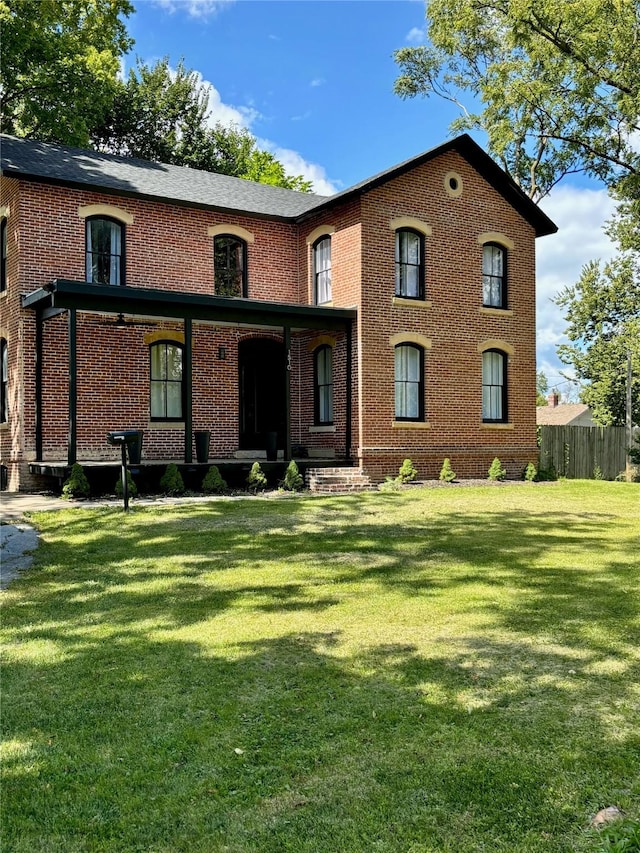 1510 9th St, Des Moines, IA 50314 - view of front of home with brick siding, fence, and a front yard