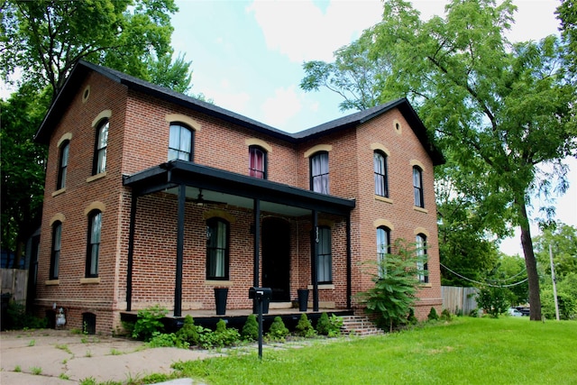 1510 9th St, Des Moines, IA 50314 - view of front of property featuring brick siding, a front lawn, and covered porch