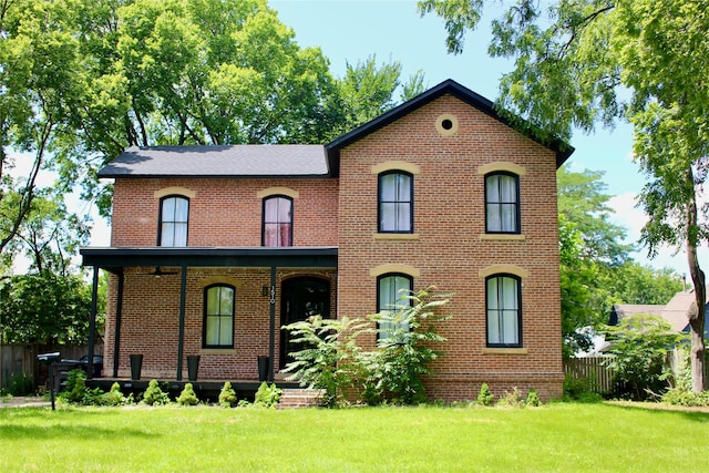 1510 9th St, Des Moines, IA 50314 - italianate-style house featuring fence, a front lawn, covered porch, and brick siding