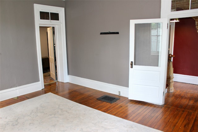 unfurnished bedroom with dark hardwood / wood-style floors