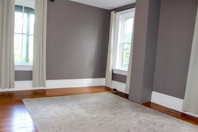 1510 9th St, Des Moines, IA 50314 - spare room featuring hardwood / wood-style floors, a healthy amount of sunlight, and baseboards