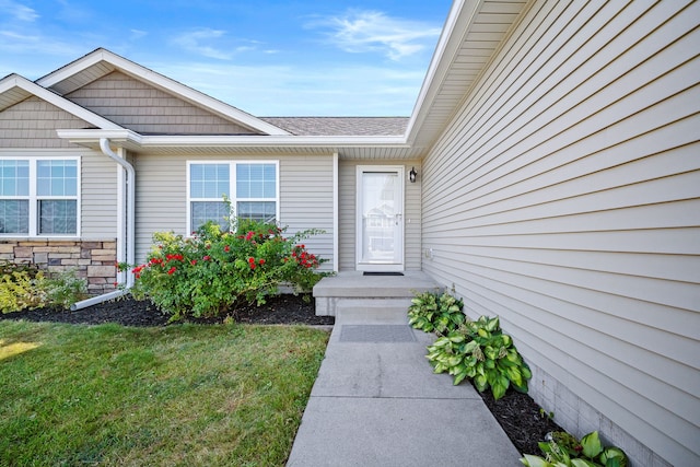 doorway to property with a lawn