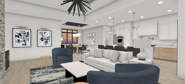 living room featuring a notable chandelier and light hardwood / wood-style floors