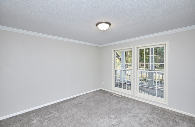 carpeted empty room featuring ornamental molding and a textured ceiling