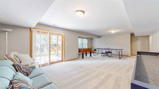 recreation room featuring light carpet