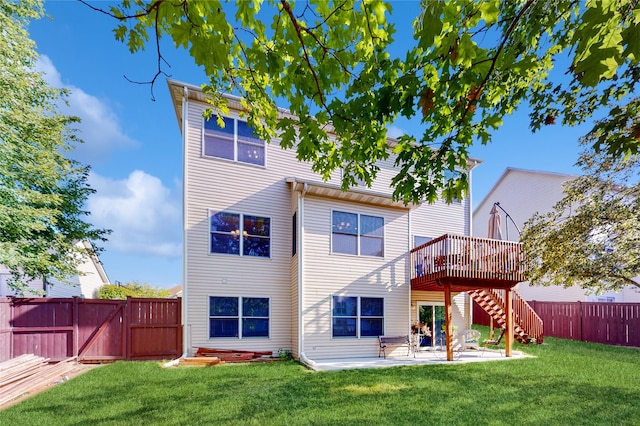 rear view of house featuring a yard and a patio