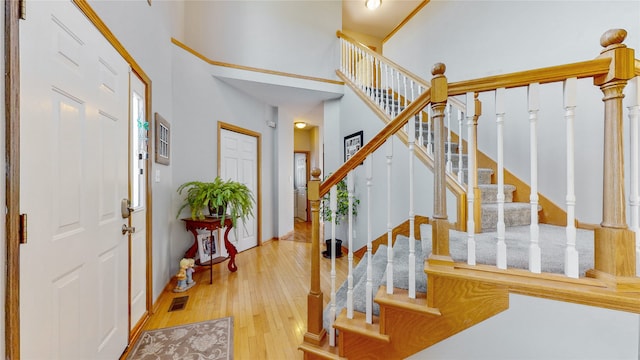 foyer featuring a high ceiling and light hardwood / wood-style floors