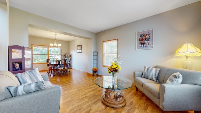 living room featuring an inviting chandelier and hardwood / wood-style flooring