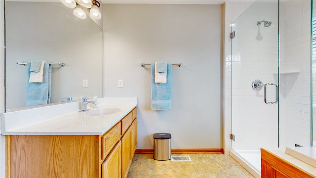 bathroom featuring an enclosed shower and vanity