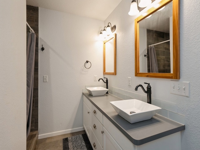 bathroom featuring wood-type flooring, a shower with curtain, and vanity