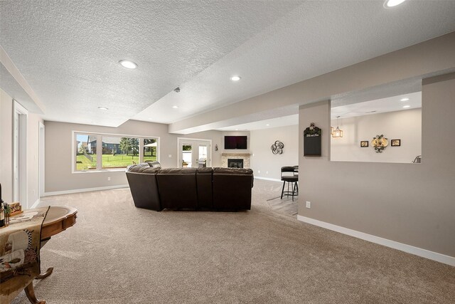 carpeted living room with a textured ceiling