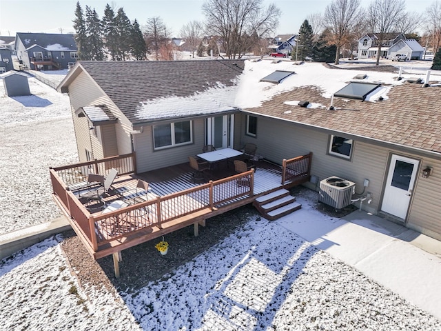 back of property with central air condition unit and a deck