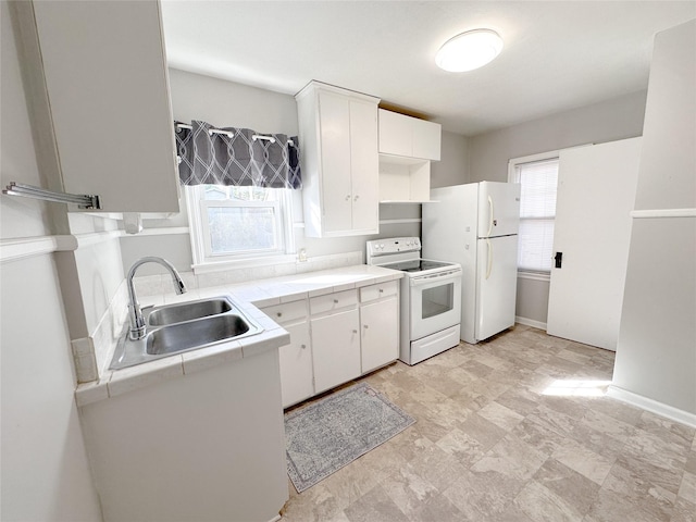 kitchen with tile counters, white cabinetry, white appliances, and sink