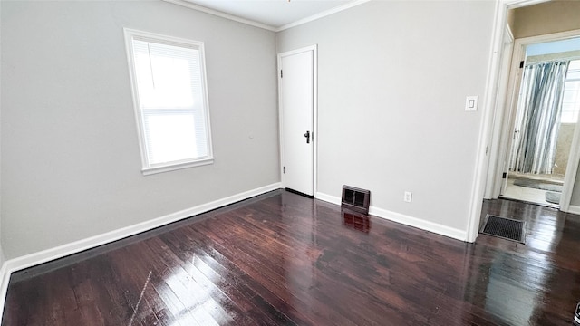 unfurnished room featuring dark hardwood / wood-style flooring and crown molding