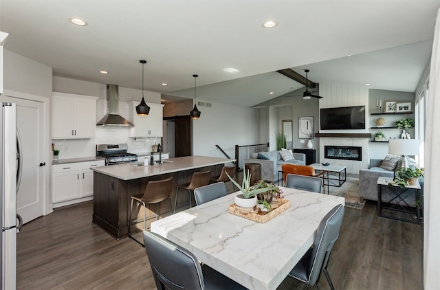 dining room with lofted ceiling with beams, dark wood-type flooring, and sink