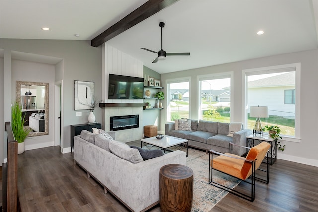 living room featuring ceiling fan, a fireplace, lofted ceiling with beams, and dark hardwood / wood-style flooring