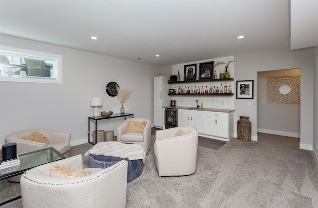 living room featuring wine cooler, carpet floors, and indoor wet bar