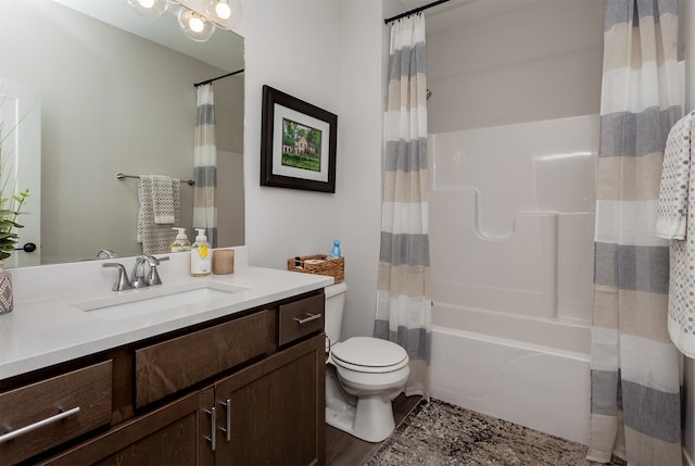 full bathroom with shower / bath combo with shower curtain, hardwood / wood-style flooring, vanity, and toilet