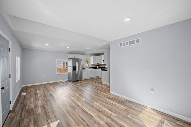 unfurnished living room with light wood-type flooring