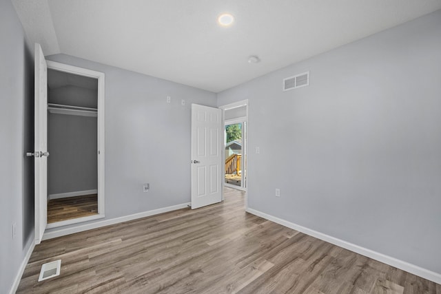 unfurnished bedroom with a closet and light hardwood / wood-style flooring