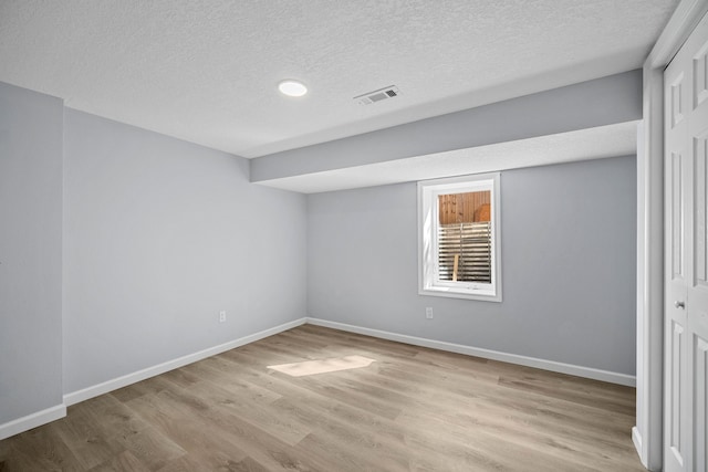 interior space with a closet, light hardwood / wood-style floors, and a textured ceiling