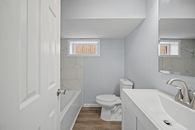 full bathroom featuring plenty of natural light, hardwood / wood-style floors, vanity, and toilet